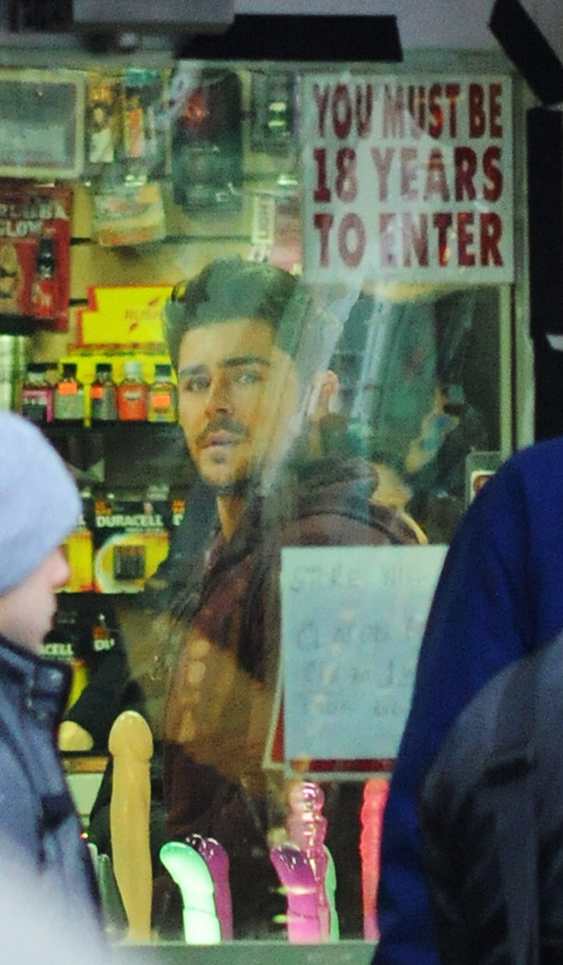 Zac Efron surrounded by dildos in a sex shop